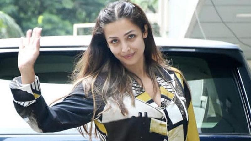 malaika arora spotted without and white spot on face outside appartment