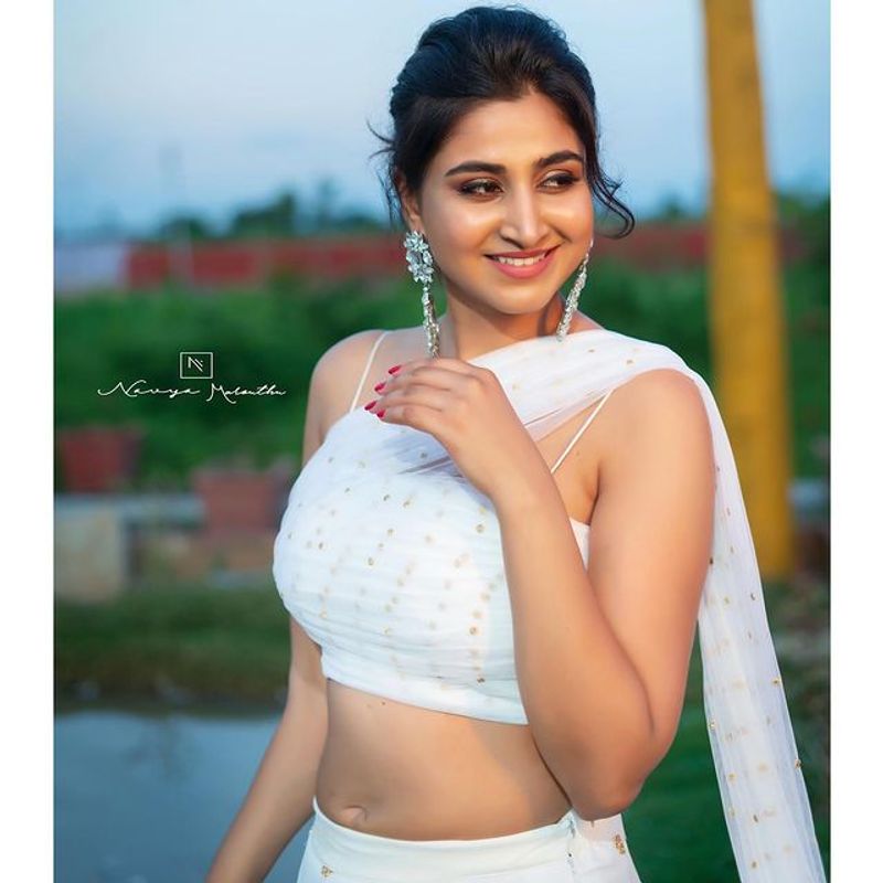 Anchor Varshini Stunning poses in white dress