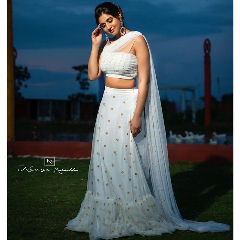 Anchor Varshini Stunning poses in white dress