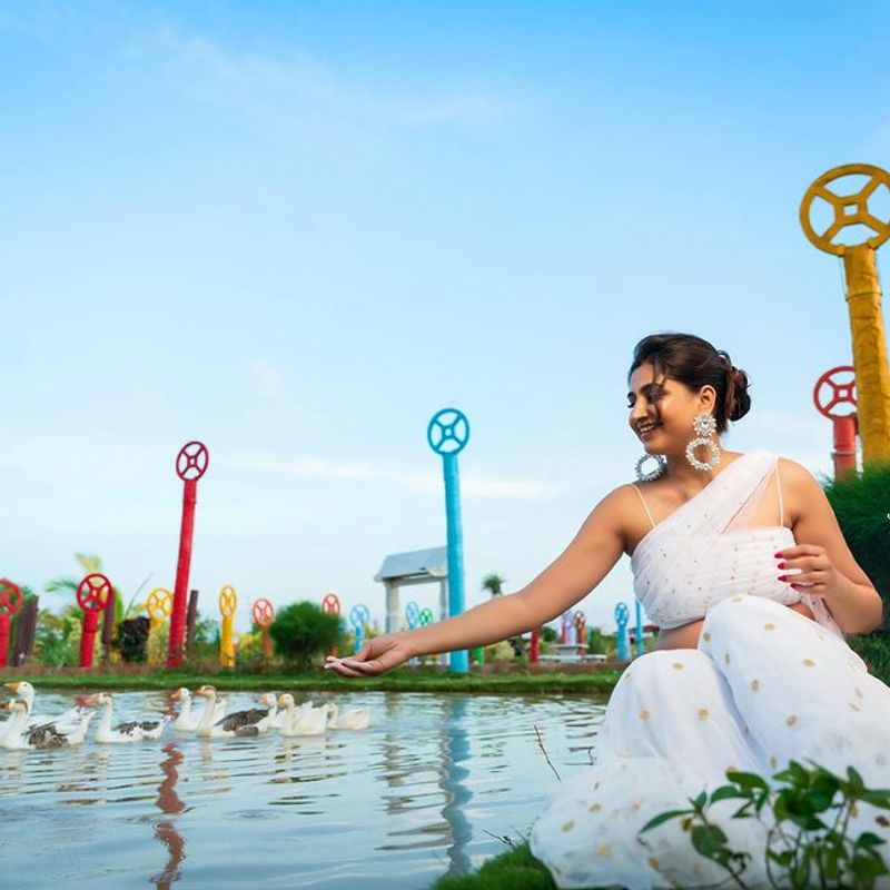 Anchor Varshini Stunning poses in white dress