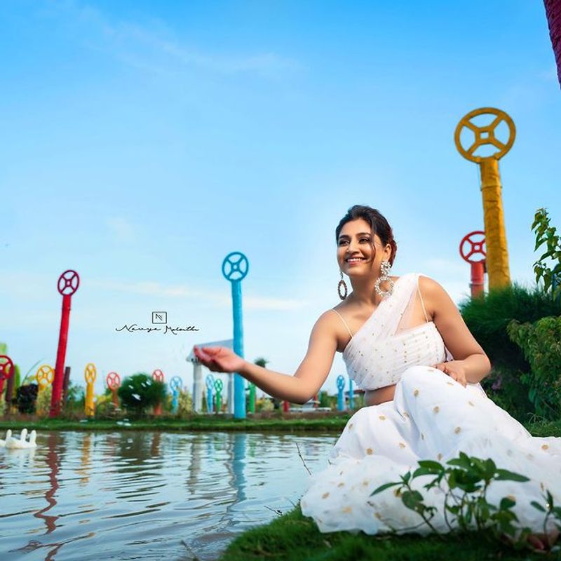 Anchor Varshini Stunning poses in white dress