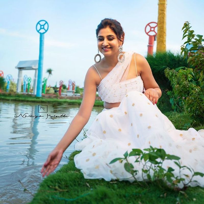 Anchor Varshini Stunning poses in white dress