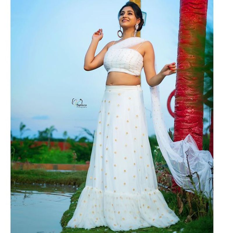Anchor Varshini Stunning poses in white dress