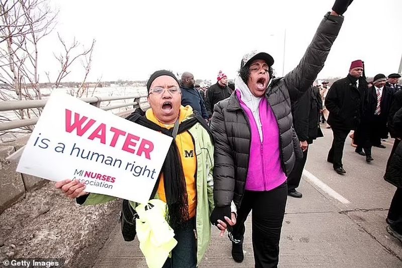 Authorities warn against drinking contaminated water people straggling for water in America