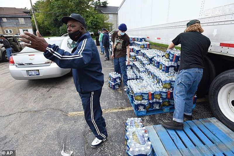 Authorities warn against drinking contaminated water people straggling for water in America