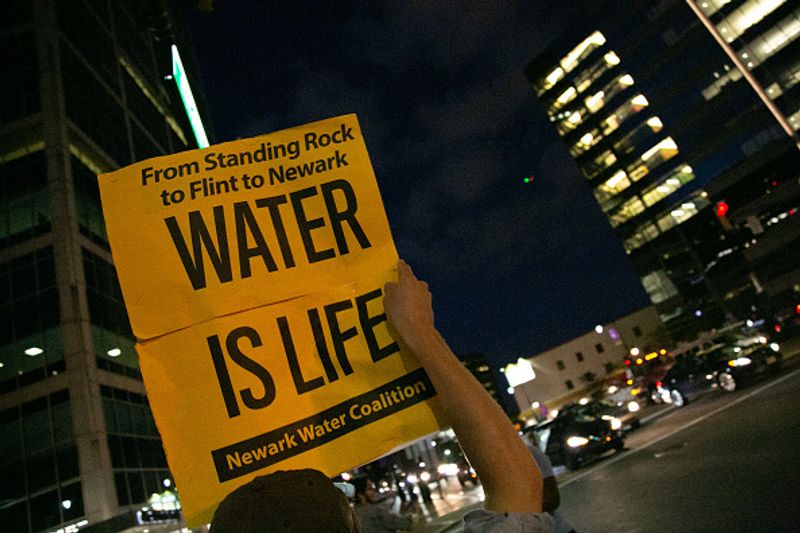 Authorities warn against drinking contaminated water people straggling for water in America
