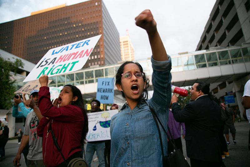 Authorities warn against drinking contaminated water people straggling for water in America