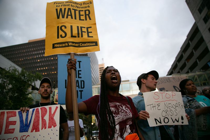Authorities warn against drinking contaminated water people straggling for water in America