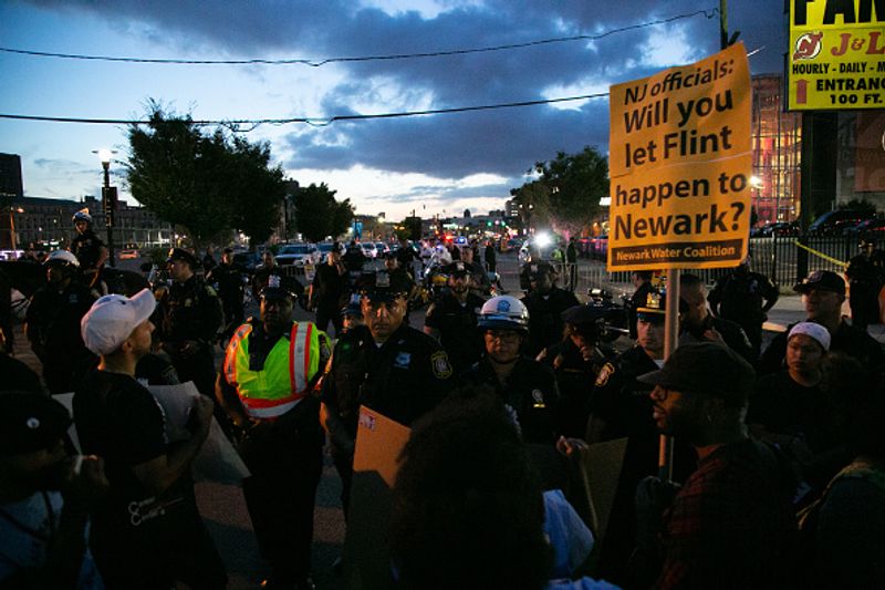 Authorities warn against drinking contaminated water people straggling for water in America