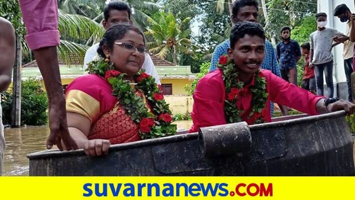 Amid heavy rains in Kerala bride and groom use cauldron to reach wedding venue pod Amid heavy rains in Kerala bride and groom use cauldron to reach wedding venue pod