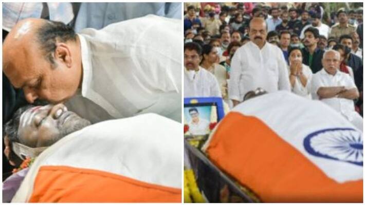 Karnataka Chief Minister Basavaraj pays last respects by kissing Puneeth Rajkumar body with tears Karnataka Chief Minister Basavaraj pays last respects by kissing Puneeth Rajkumar body with tears