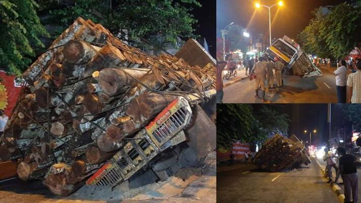 heavy loaded wood lorry fell into pothole in main road in Thiruvananthapuram heavy loaded wood lorry fell into pothole in main road in Thiruvananthapuram