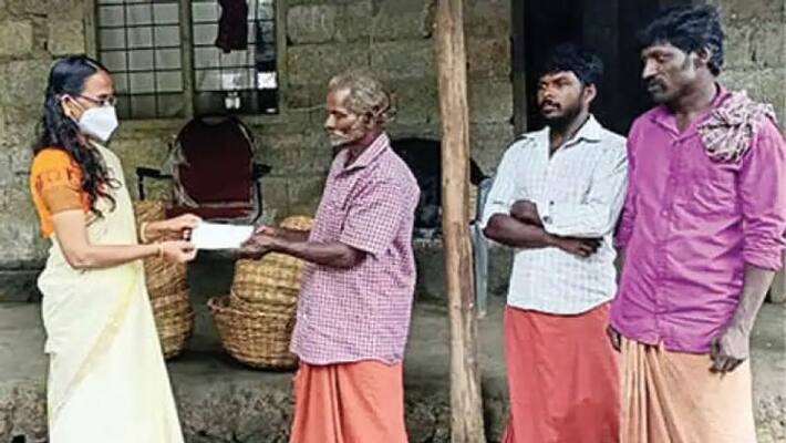 agriculture officer hand over the tapioca sold money to tribal farmer agriculture officer hand over the tapioca sold money to tribal farmer