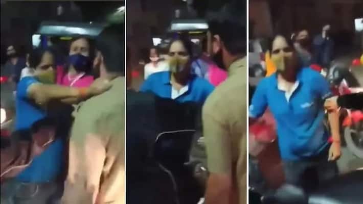 Delhi woman slaps car driver in the middle of the road viral Delhi woman slaps car driver in the middle of the road viral