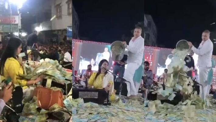 Gujarati singer is showered with bucketful of notes in viral video Gujarati singer is showered with bucketful of notes in viral video