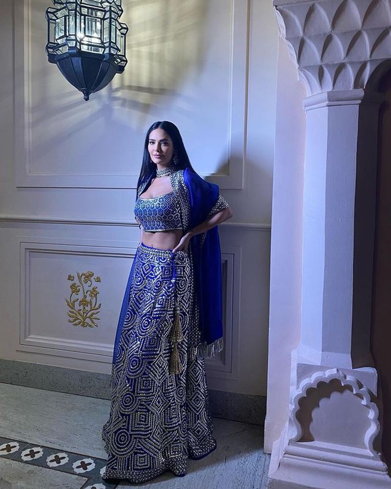 Esha Gupta maid blowing pose in blue lehenga