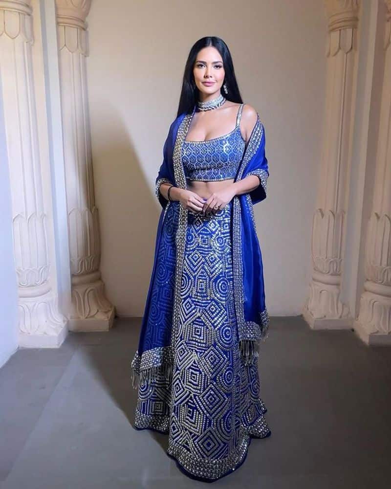 Esha Gupta maid blowing pose in blue lehenga