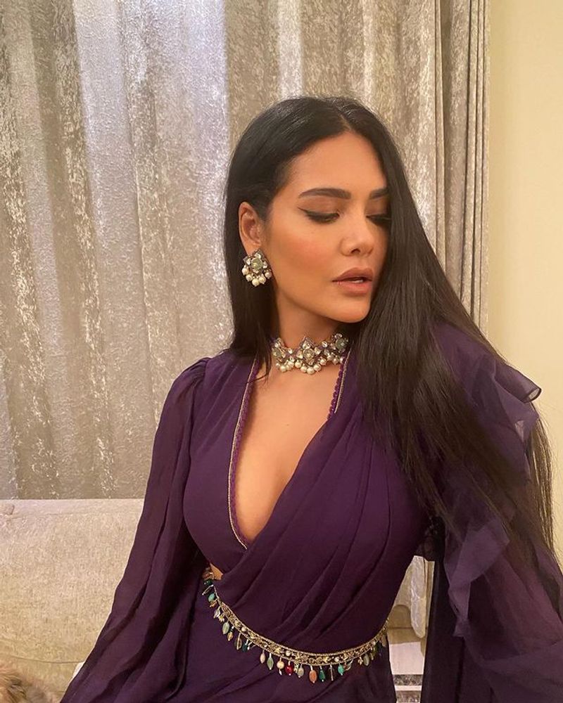 Esha Gupta maid blowing pose in blue lehenga