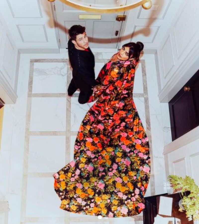 Priyanka Chopra cant stop smiling as Nick Jonas fixes her outfit on red carpet at British Fashion Awards 2021 dpl