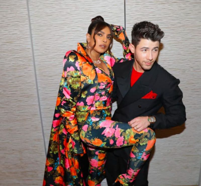 Priyanka Chopra cant stop smiling as Nick Jonas fixes her outfit on red carpet at British Fashion Awards 2021 dpl