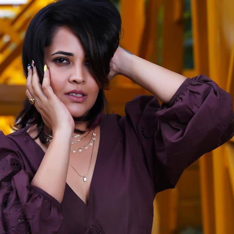 Anchor Anasuya stunning hot poses in short gown