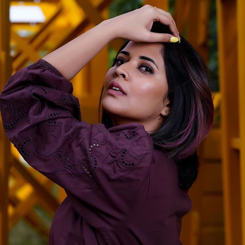 Anchor Anasuya stunning hot poses in short gown