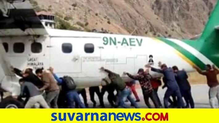 Viral video Passengers push airplane off runway after tyre burst at Nepal airport mnj Viral video Passengers push airplane off runway after tyre burst at Nepal airport mnj