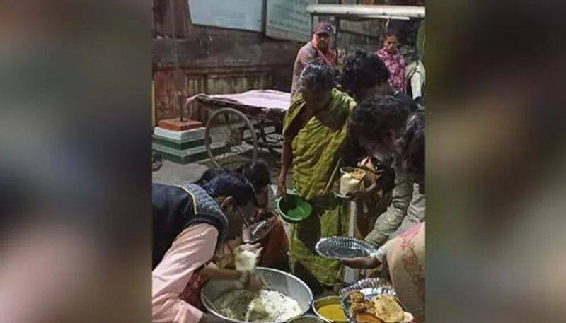 woman distributes food for homeless people after her brothers wedding reception