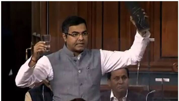 bjp mp shows liquor in parliament to criticise delhi govt bjp mp shows liquor in parliament to criticise delhi govt