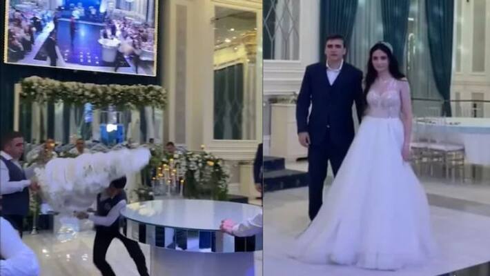 Bride and groom shocked as hotel staff drops wedding cake by mistake in viral video Bride and groom shocked as hotel staff drops wedding cake by mistake in viral video