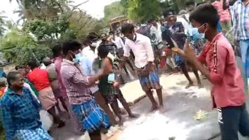 People protest by pouring Pongal gift package on the road