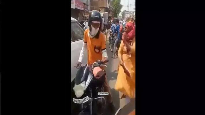 Woman thrashes food delivery boy with shoe after he hits her scooter Woman thrashes food delivery boy with shoe after he hits her scooter