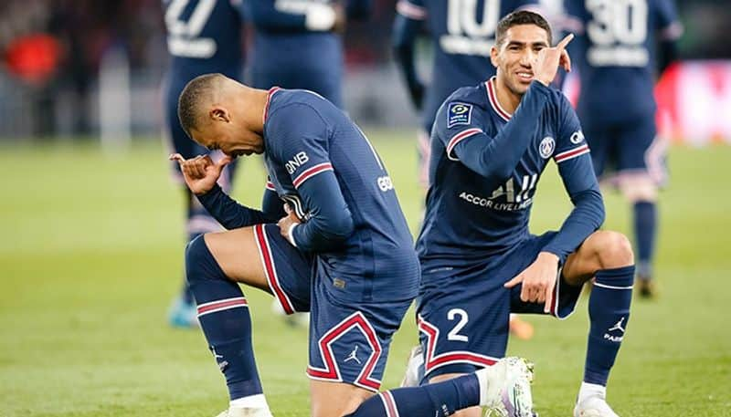 PSG striker Kylian Mbappe shows his jersey with PSG president Nasser  Al-Khelaifi during a press conference Monday, May 23, 2022 at the Paris des  Princes stadium in Paris. Kylian Mbappé's decision to