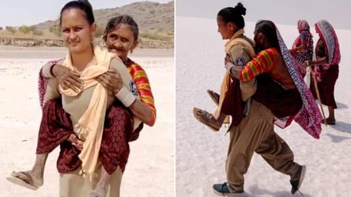 Woman cop carries elderly woman on shoulders for 5 kms in Kutch desert; wins netizens' hearts-tgy Woman cop carries elderly woman on shoulders for 5 kms in Kutch desert; wins netizens' hearts-tgy