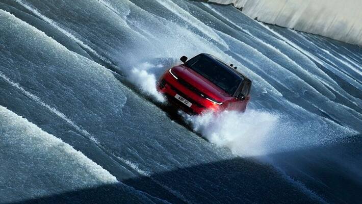 Range Rover Sport complet challenging ascent dam spillway against a torrent of water flowing ckm Range Rover Sport complet challenging ascent dam spillway against a torrent of water flowing ckm