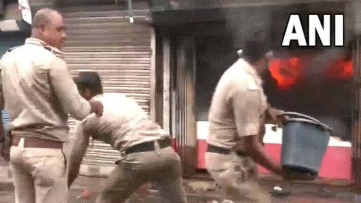 Howrah Violence Police are putting out fire at shop in Panchla Bazar RTB Howrah Violence Police are putting out fire at shop in Panchla Bazar RTB
