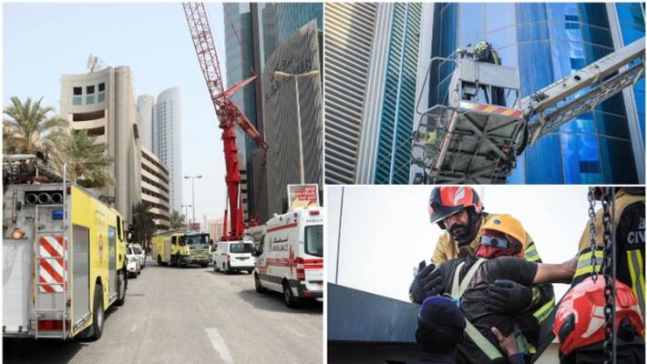 Cleaners trapped in crane on high rise building in Bahrain rescued by civil defence Cleaners trapped in crane on high rise building in Bahrain rescued by civil defence