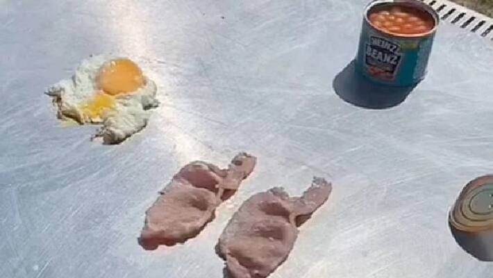 man cooks breakfast in suns heat amid heat wave man cooks breakfast in suns heat amid heat wave