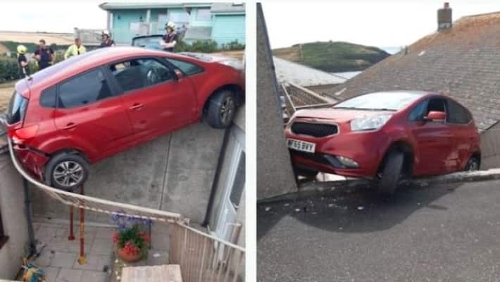 Car left wedged between two buildings after knocking over railings apa 