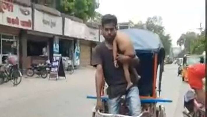 Man carry her son during pulling rikshaw know his real story apa Man carry her son during pulling rikshaw know his real story apa