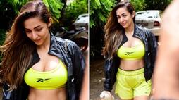 Sexy pictures bollywood diva Malaika Arora flaunts her assets in florescent green cleavage revealing sports bra and shorts snt