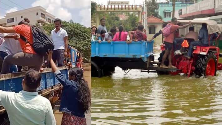 IT employees reach office on tractor to escape knee-high water due to Bengaluru rains apa IT employees reach office on tractor to escape knee-high water due to Bengaluru rains apa