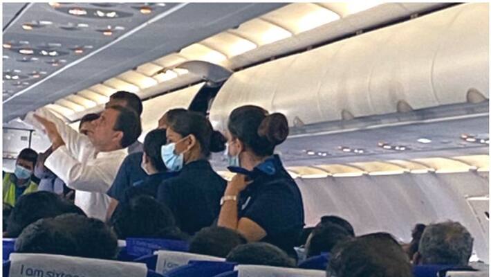 Rahul Gandhi helping co passenger on a flight viral photo Rahul Gandhi helping co passenger on a flight viral photo