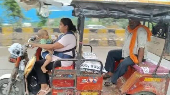 woman driving E-rickshaw with her one year old son in UP's Noida akb woman driving E-rickshaw with her one year old son in UP's Noida akb