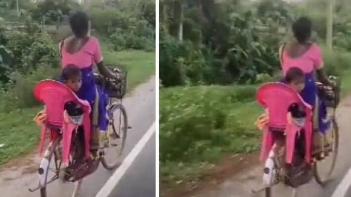 Mother makes variety backseat for child on bicycle Mother makes variety backseat for child on bicycle