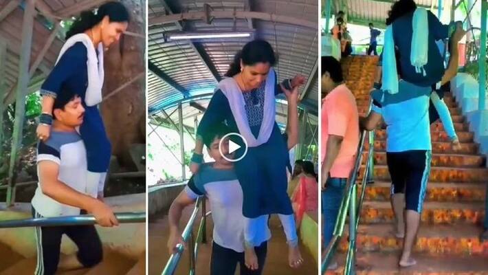 Man from East godavri climbs tirumala hill carrying wife on shoulder video goes viral akb Man from East godavri climbs tirumala hill carrying wife on shoulder video goes viral akb