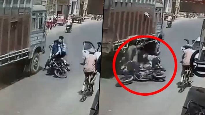 Bikers colliding into a moving truck shows why one should carefully open car's door; watch video here - gps Bikers colliding into a moving truck shows why one should carefully open car's door; watch video here - gps