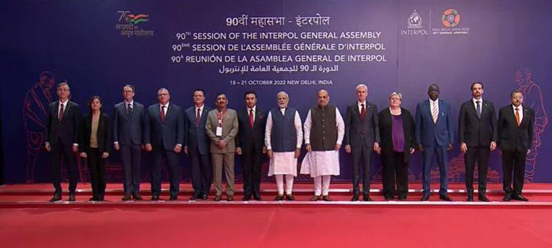 PM Modi unveils commemorative postal stamps and Rs 100 coins at the 90th Interpol General Assembly.