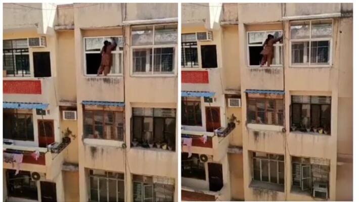 woman daredevil cleans window from outside of their home which was in fourth floor of the apartment woman daredevil cleans window from outside of their home which was in fourth floor of the apartment