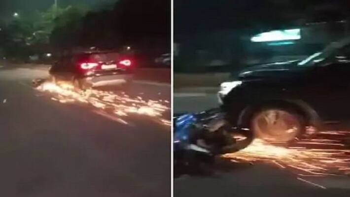 Ghaziabad car driver dragged bike for 1 km sparks kept coming out and people kept shouting Ghaziabad car driver dragged bike for 1 km sparks kept coming out and people kept shouting
